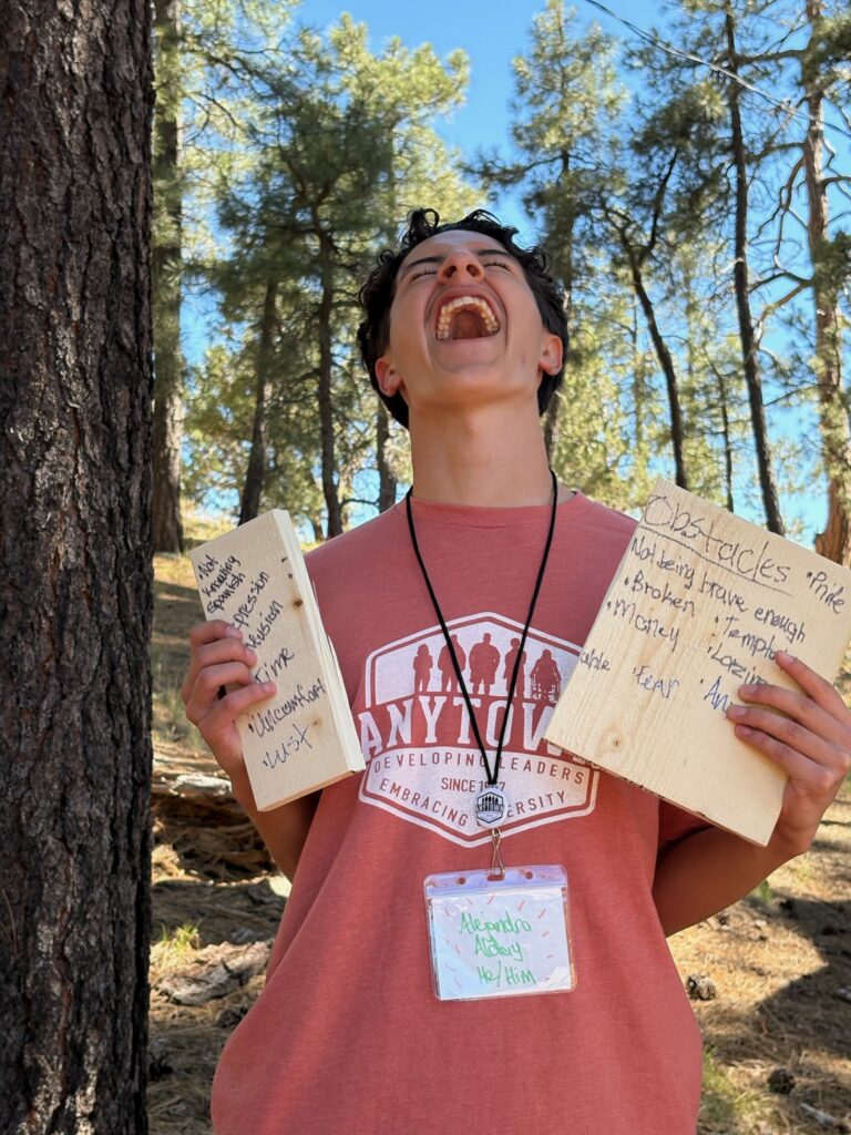 Smiling delegate holding goal boards at camp
