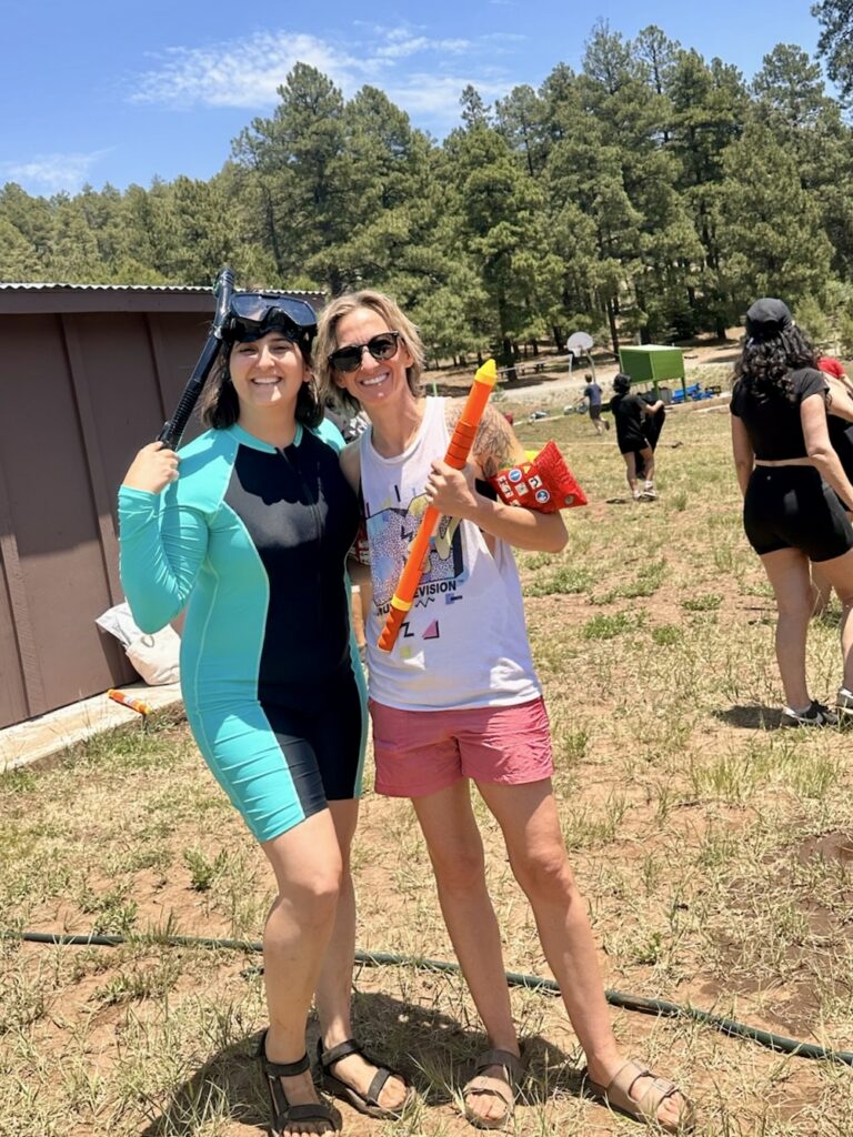 Two Anytown staff members with water guns outdoors