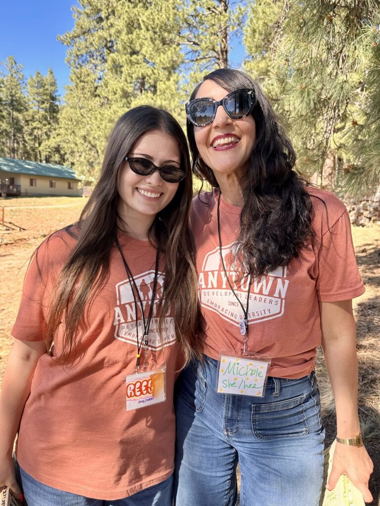 Two Anytown staff members smiling in their camp shirts