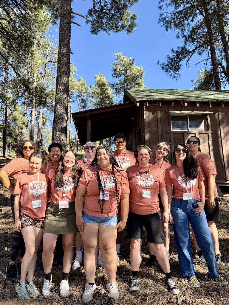 Anytown advisors smiling together at camp