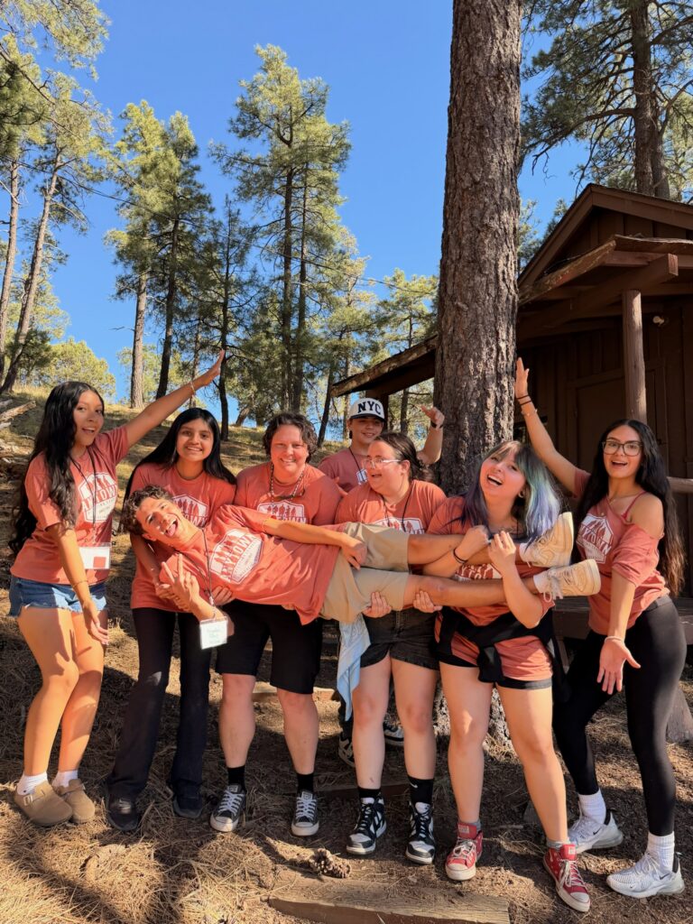 Anytown delegates laughing and lifting a fellow camper