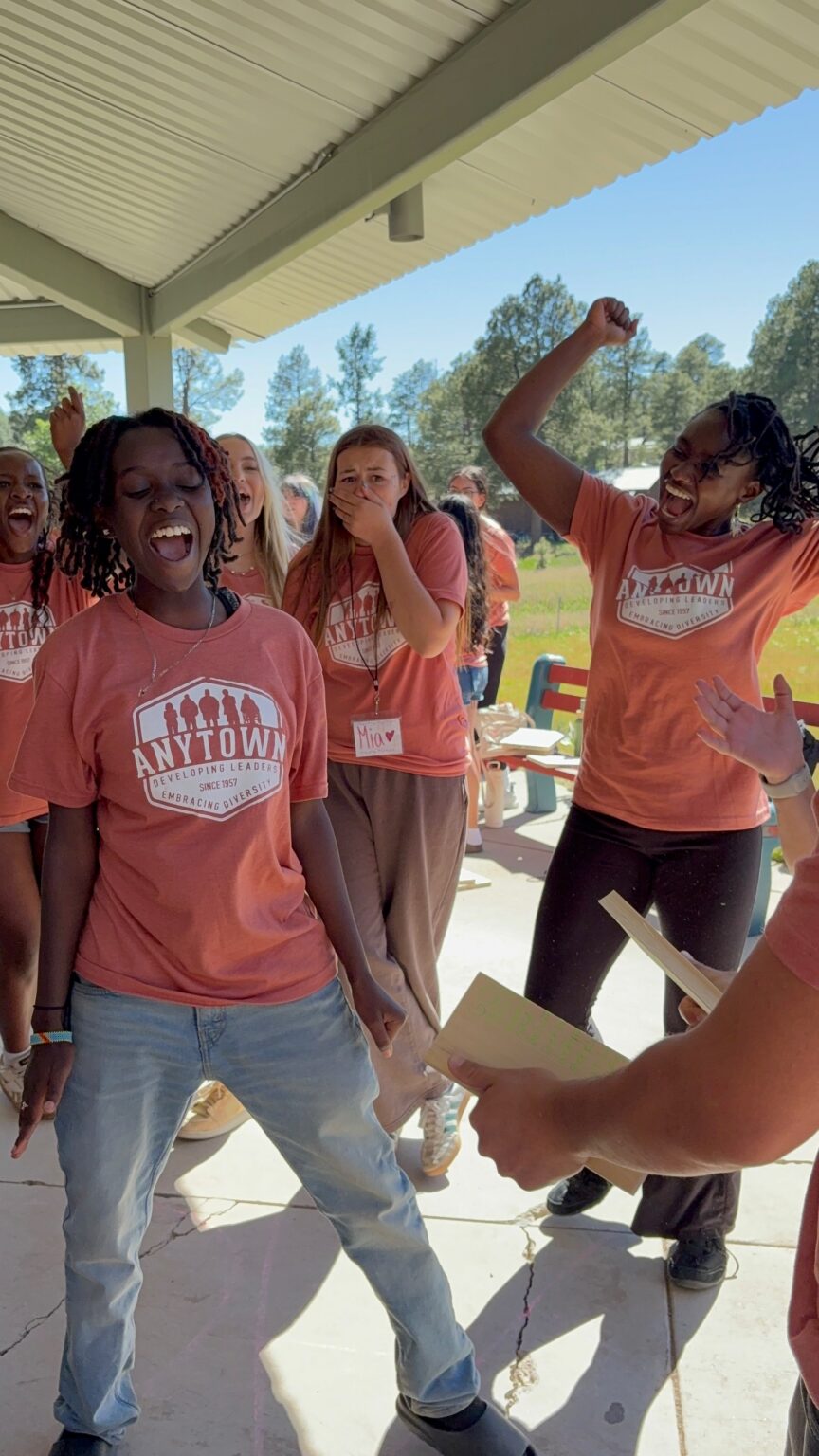 Delegates cheering and celebrating together at camp