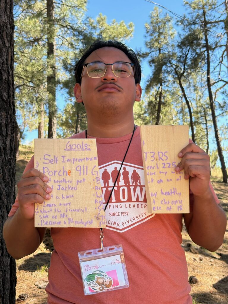 Abraham, Anytown delegate, holding his goal boards at camp
